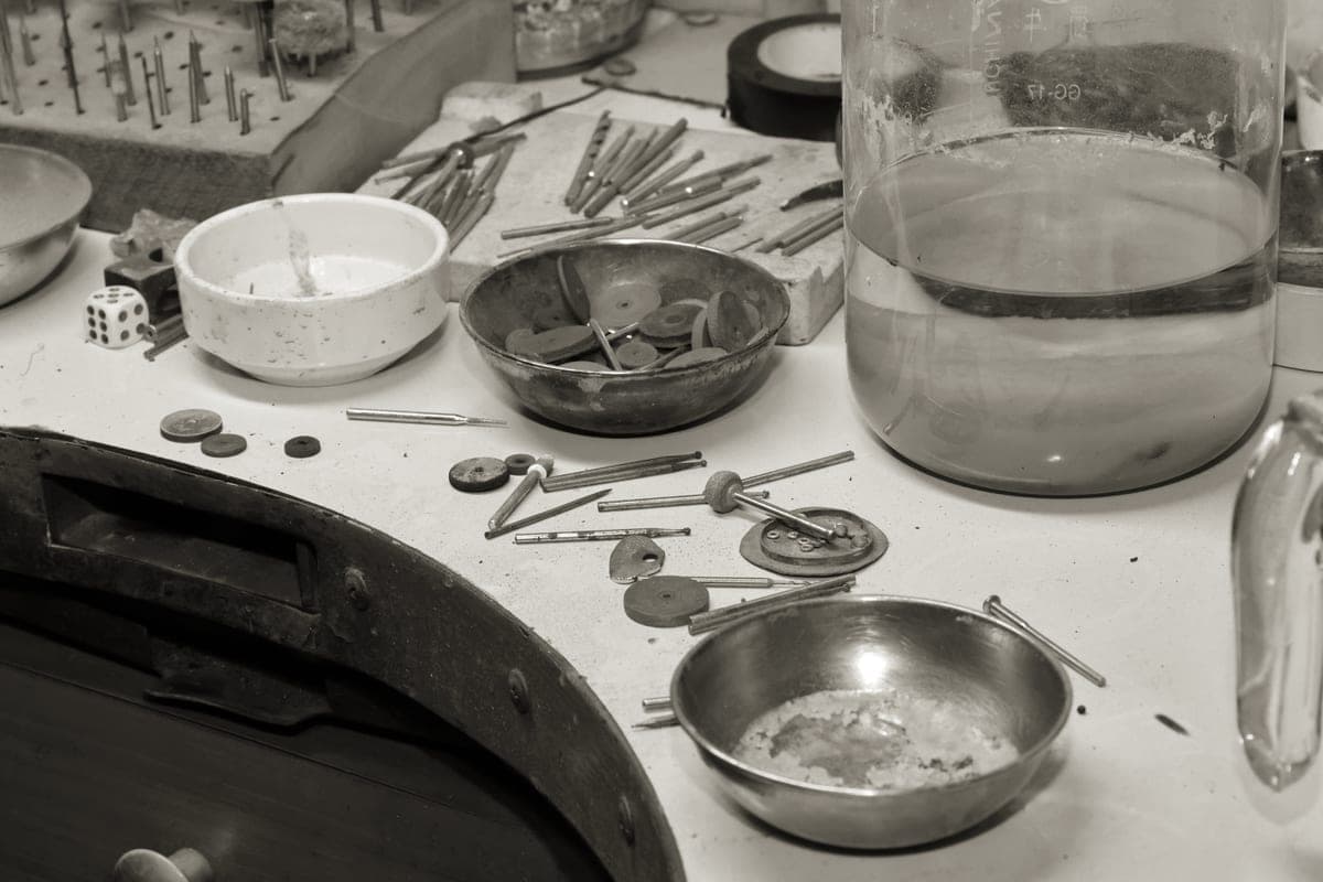 A jeweller's workbench with hand tools and materials